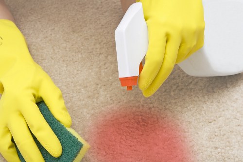 Professional home cleaners working in a W12 living room