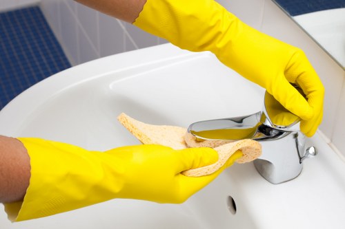W12 office cleaner sanitising a kitchen and break area
